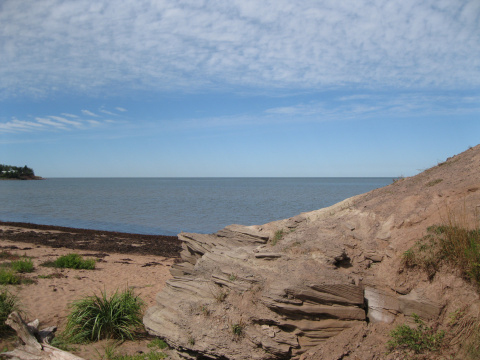 View of Waterside Beach with large rocks in the foreground